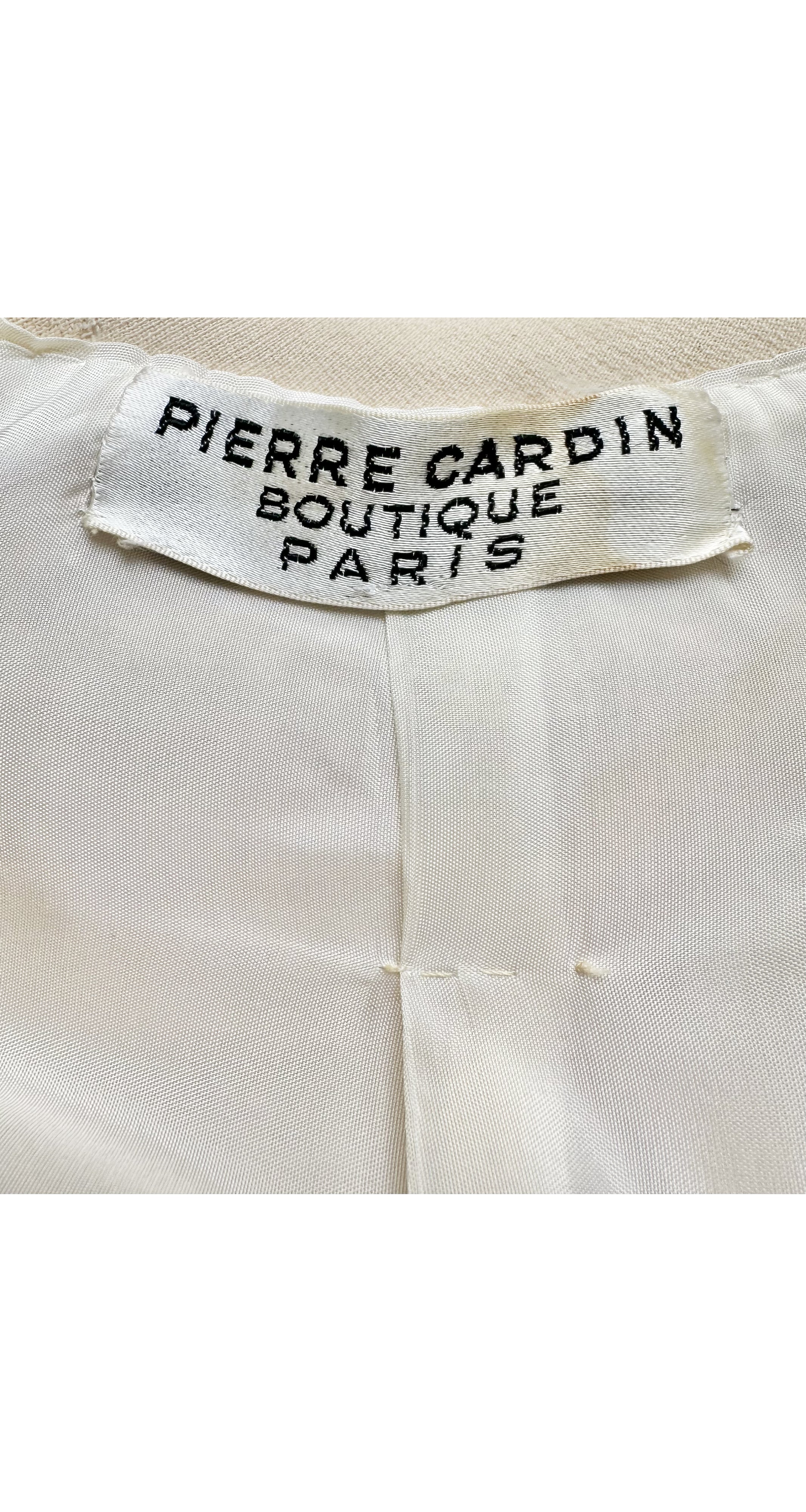 Label photo of 1969 Pierre Cardin cream wool coat on mannequin