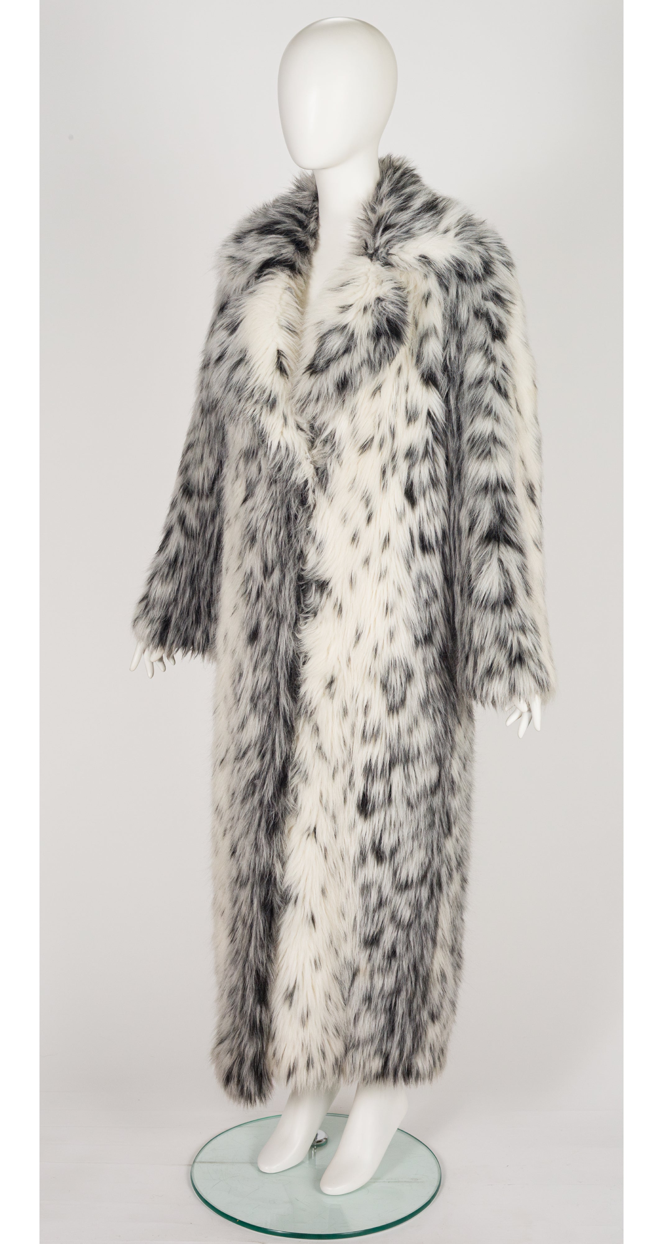 3/4 shot of 1970s faux lynx fur full-length coat on mannequin