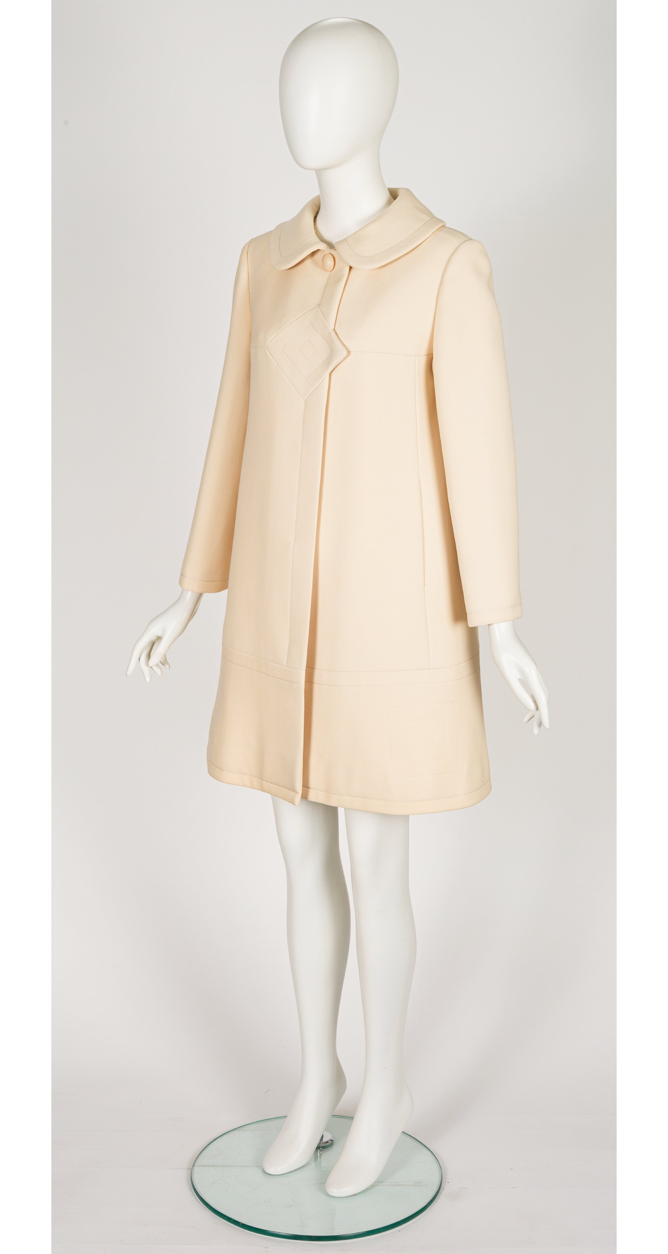 3/4 shot of 1969 Pierre Cardin cream wool coat on mannequin
