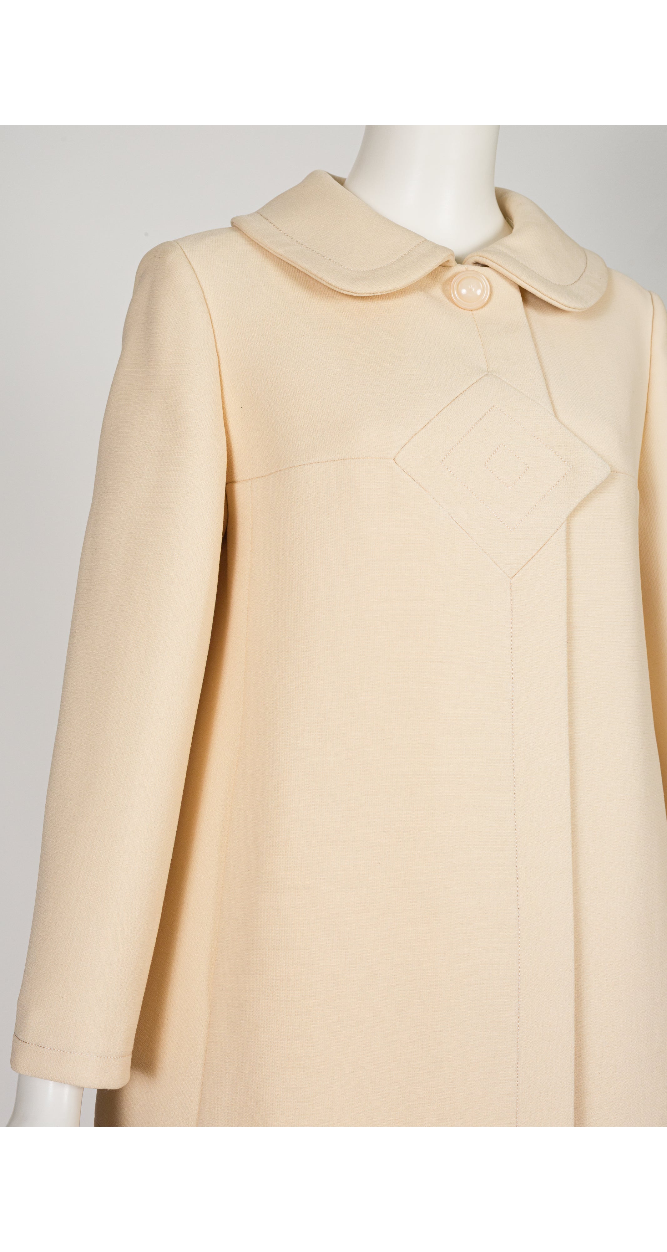 close up of 1969 Pierre Cardin cream wool coat on mannequin