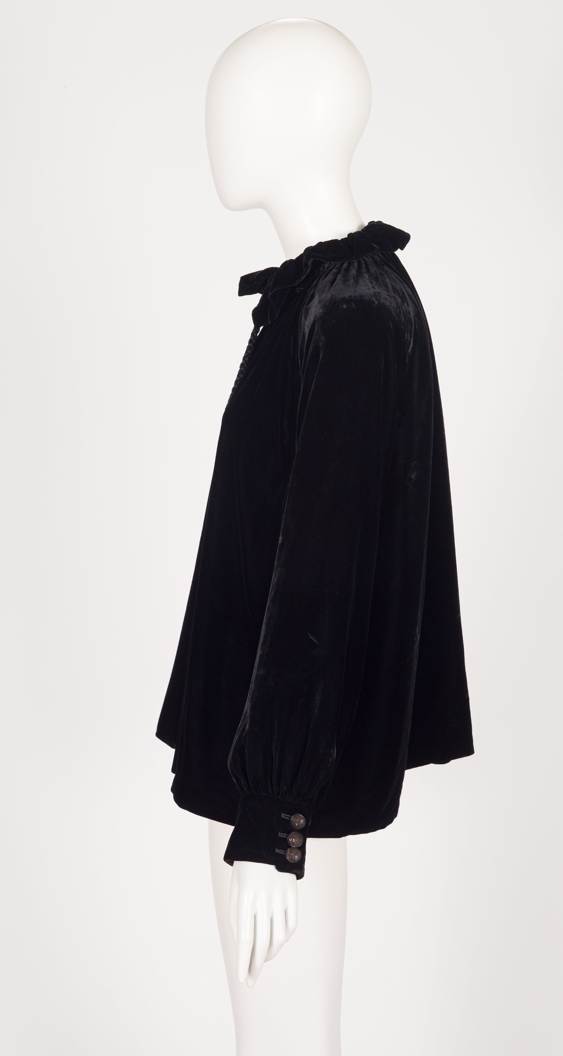 side of 2012 Gucci black velvet tassel blouse on mannequin