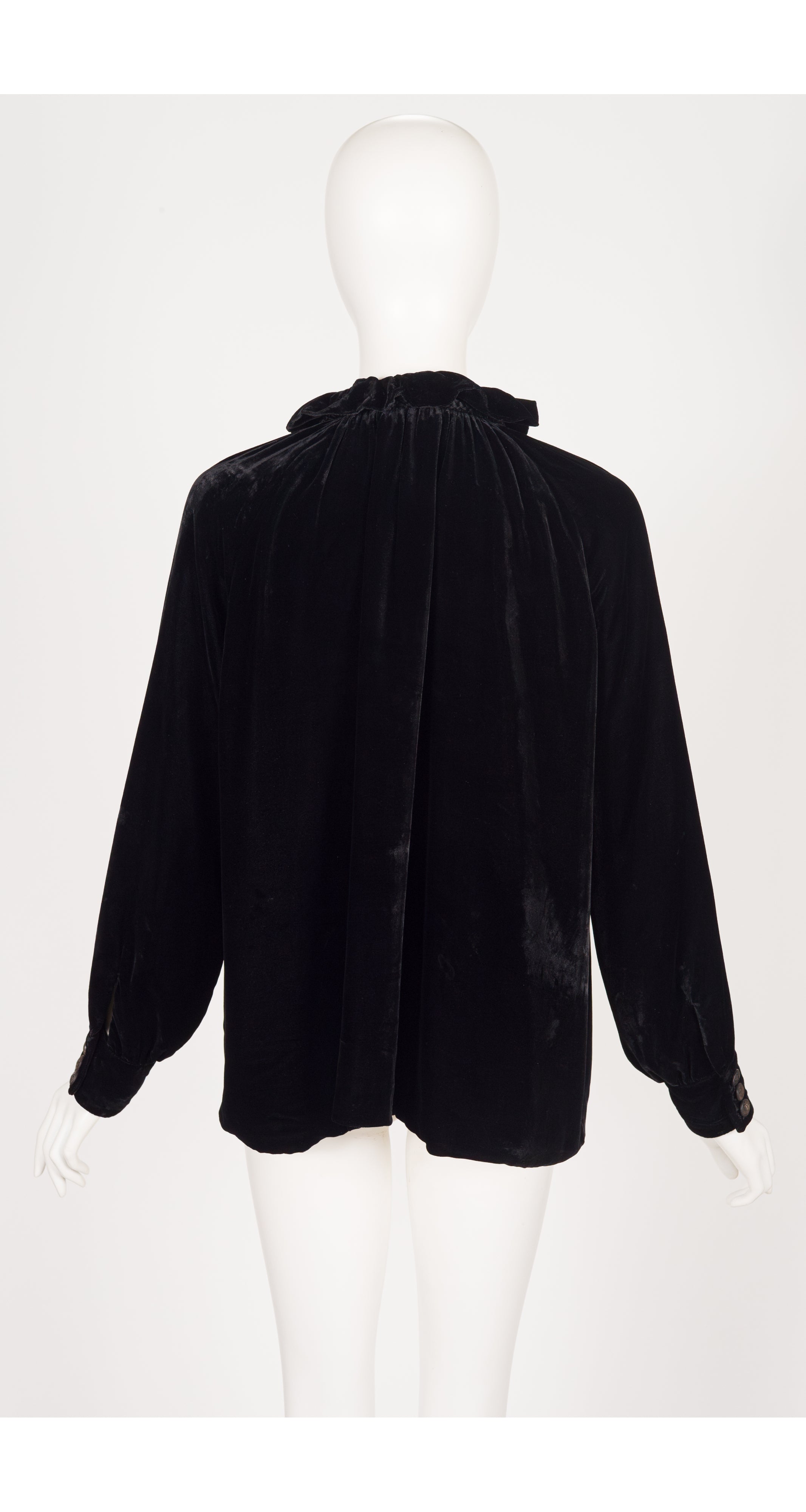 back of 2012 Gucci black velvet tassel blouse on mannequin