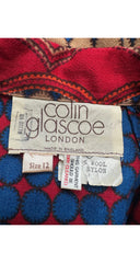 Close-up of a vintage Colin Glascoe London garment label on a red and blue patterned fabric background.