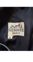 1970s Hermès Paris label on a dark fabric background