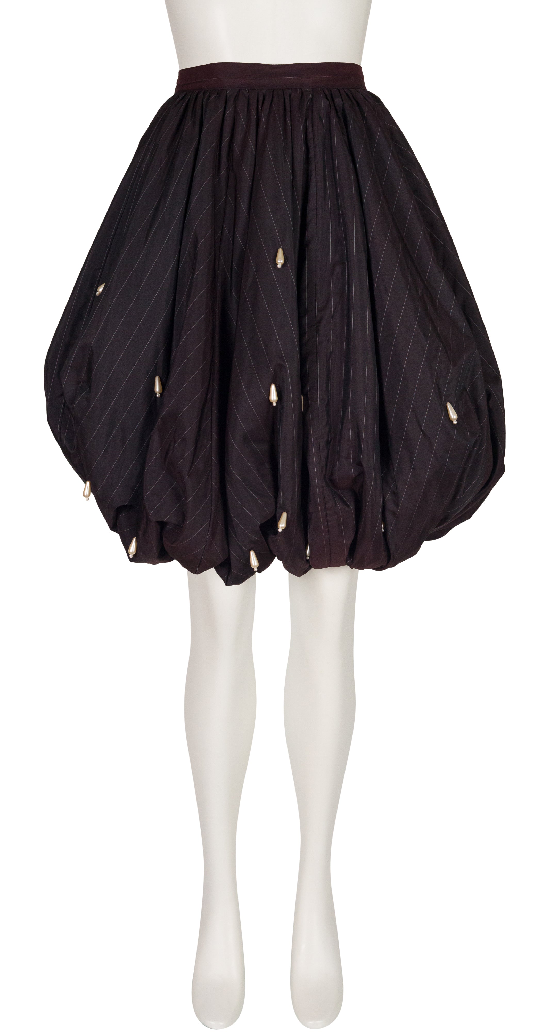 A Krizia 1980s pinstripe black bubble hem skirt with pearl teardrop beads on a white mannequin with a white background. 