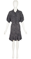 Black patterned dress on a white mannequin against a white background