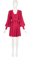 A 1970s Jeff Banks red puff-sleeve mini dress with a small repeating floral pattern, displayed on a white mannequin against a plain white background.