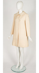 3/4 shot of 1969 Pierre Cardin cream wool coat on mannequin 