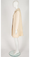 Side of 1969 Pierre Cardin cream wool coat on mannequin 